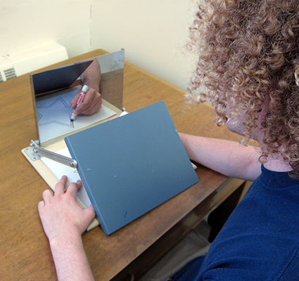 picture of someone tracing on paper with mirror